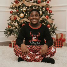 Load image into Gallery viewer, Boy in Christmas reindeer pajamas
