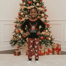 Load image into Gallery viewer, Girl in Christmas reindeer pajamas
